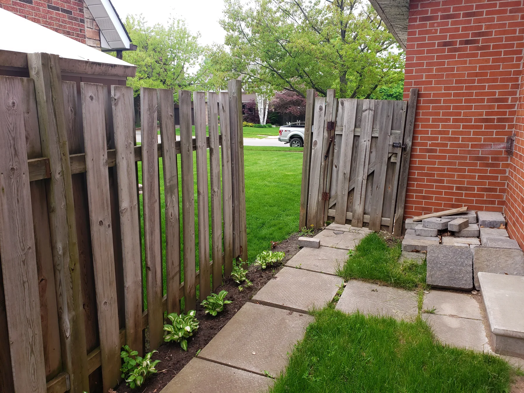 Weathered side-yard fence and gate before replacement