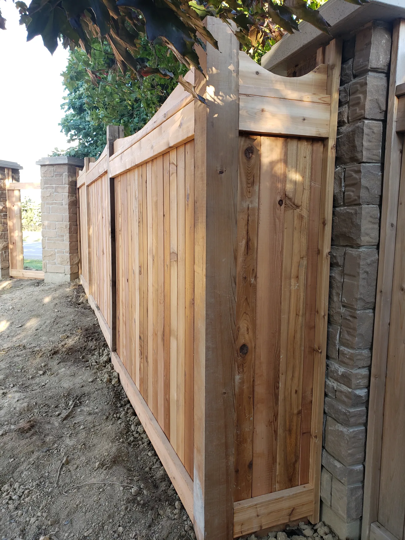 Cedar fence joined to existing stone pillars