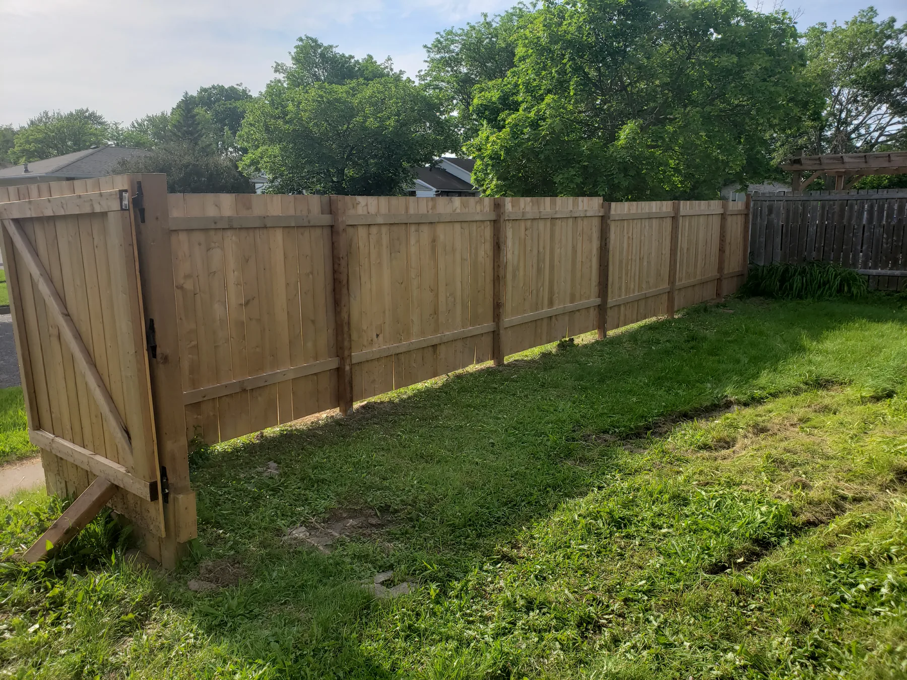 Interior view of cedar fence posts, rails, and gate framing