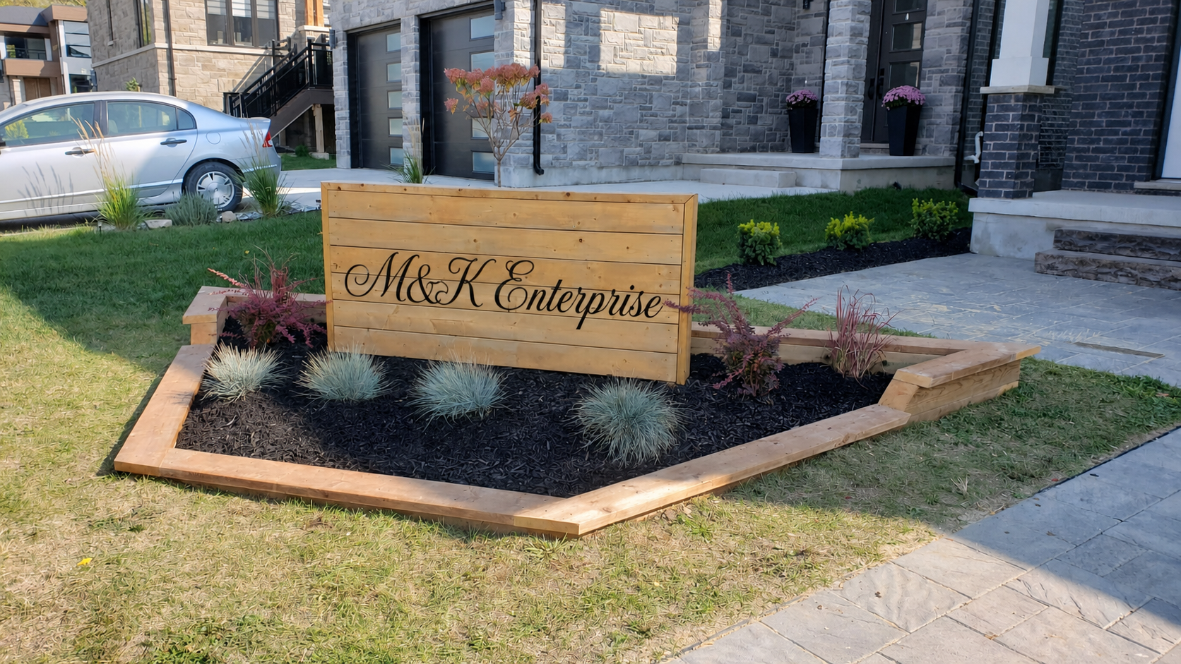 Custom cedar flower bed with a cursive M&K Enterprise sign