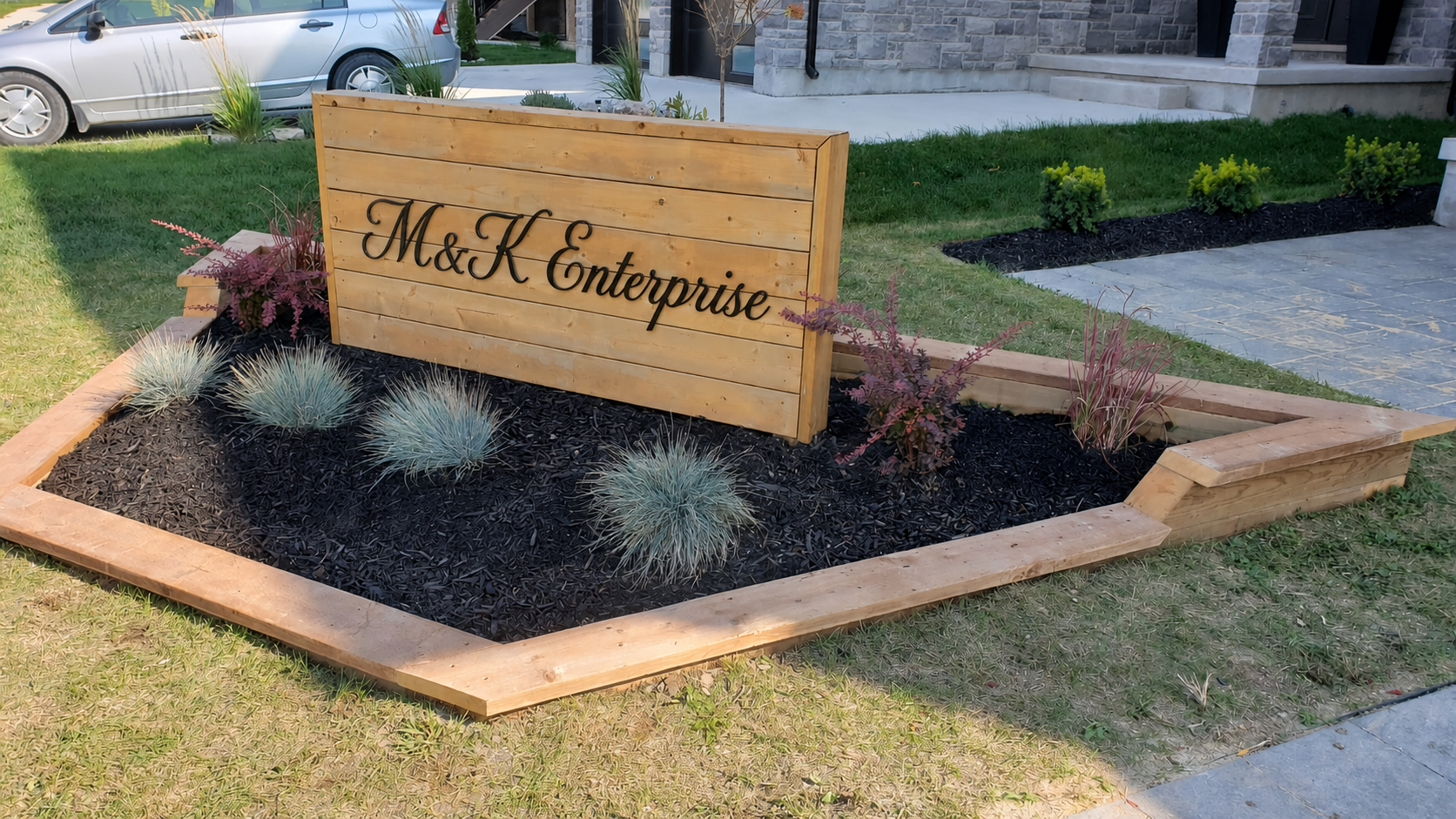 M&K Enterprise sign centred within the custom flower bed