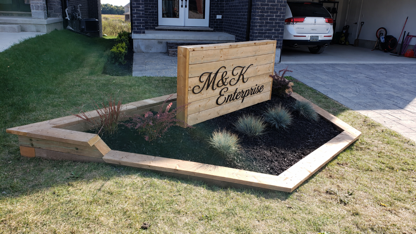 Angled view of the cedar flower bed and finished sign