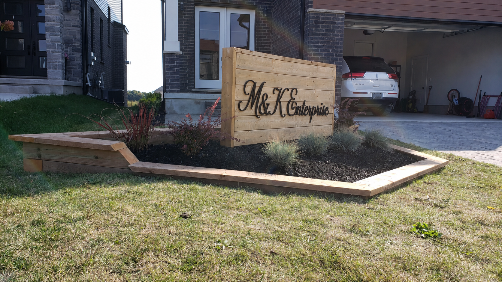 Completed custom flower bed beside the driveway