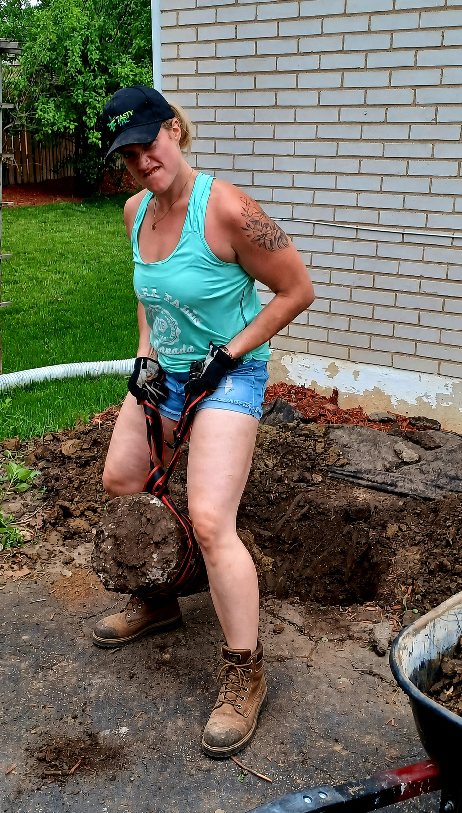 Kim working on a residential outdoor project in steel-toe work boots