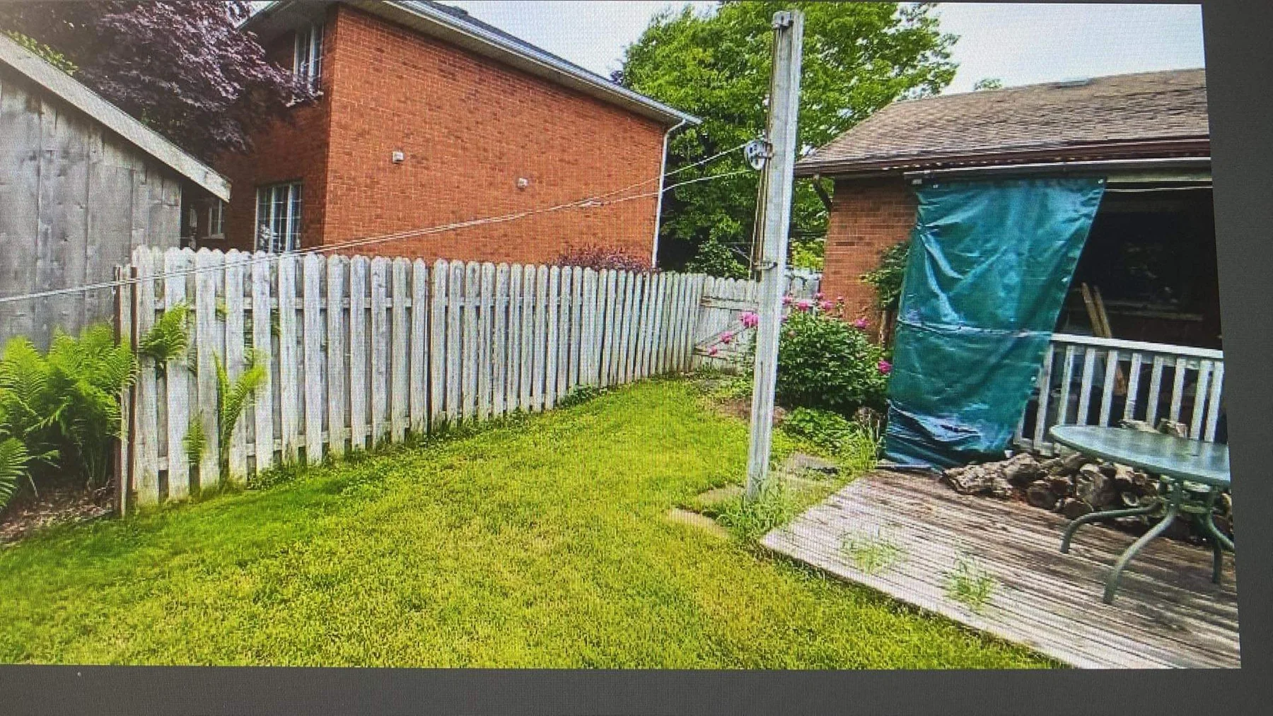Aged garden fence before replacement