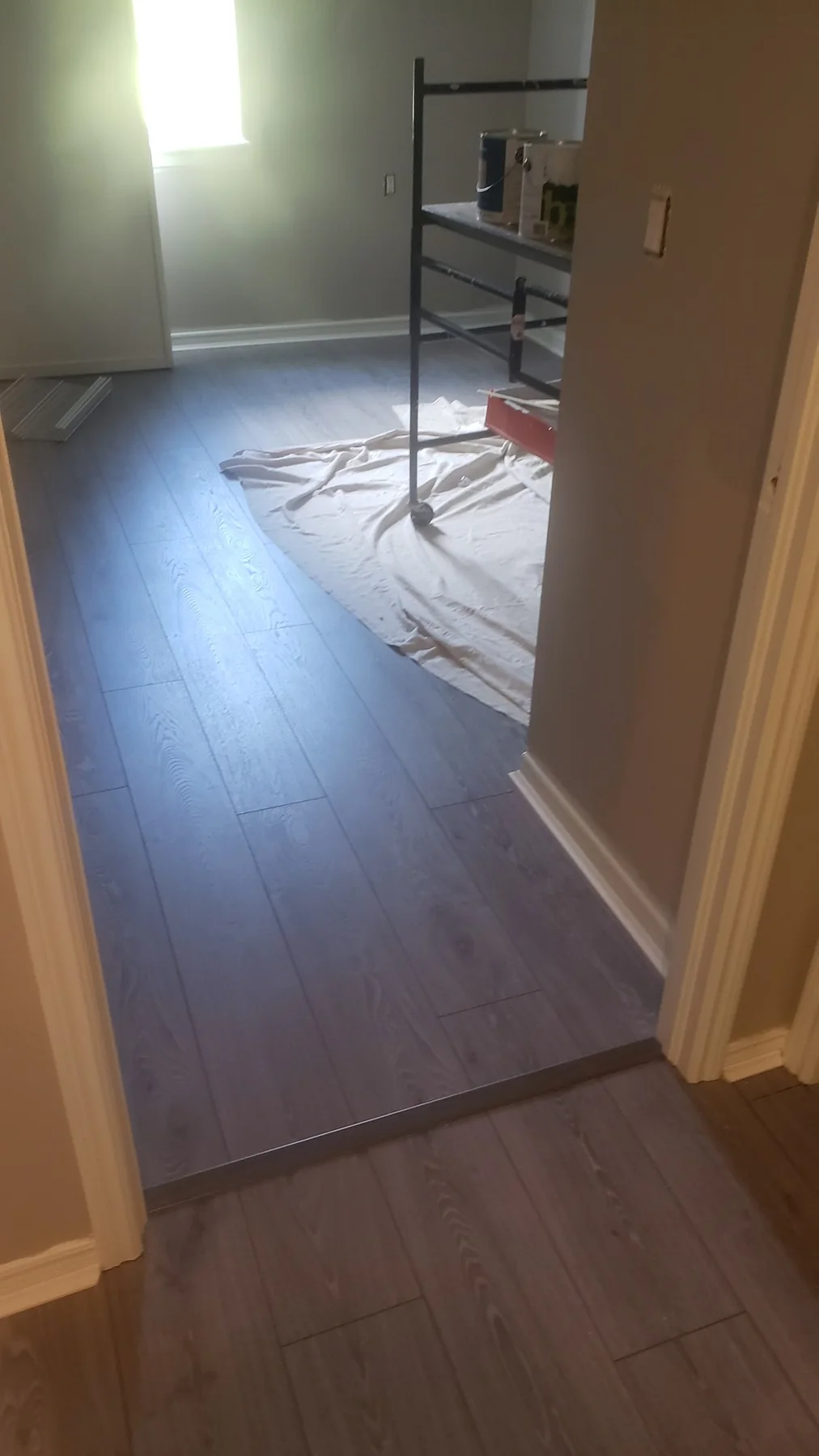 Completed grey plank flooring through a residential living area