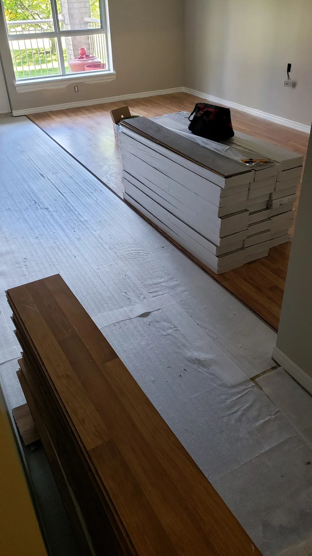 Warm wood-look flooring materials staged during installation