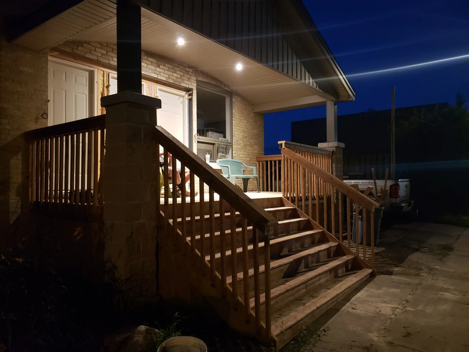 Side view of the raised deck, railings, posts, and lighting
