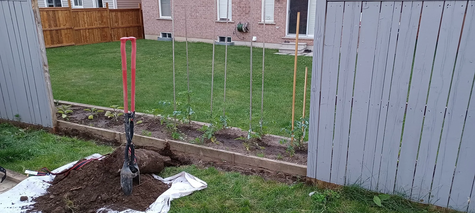 Damaged fence post and footing exposed during repair