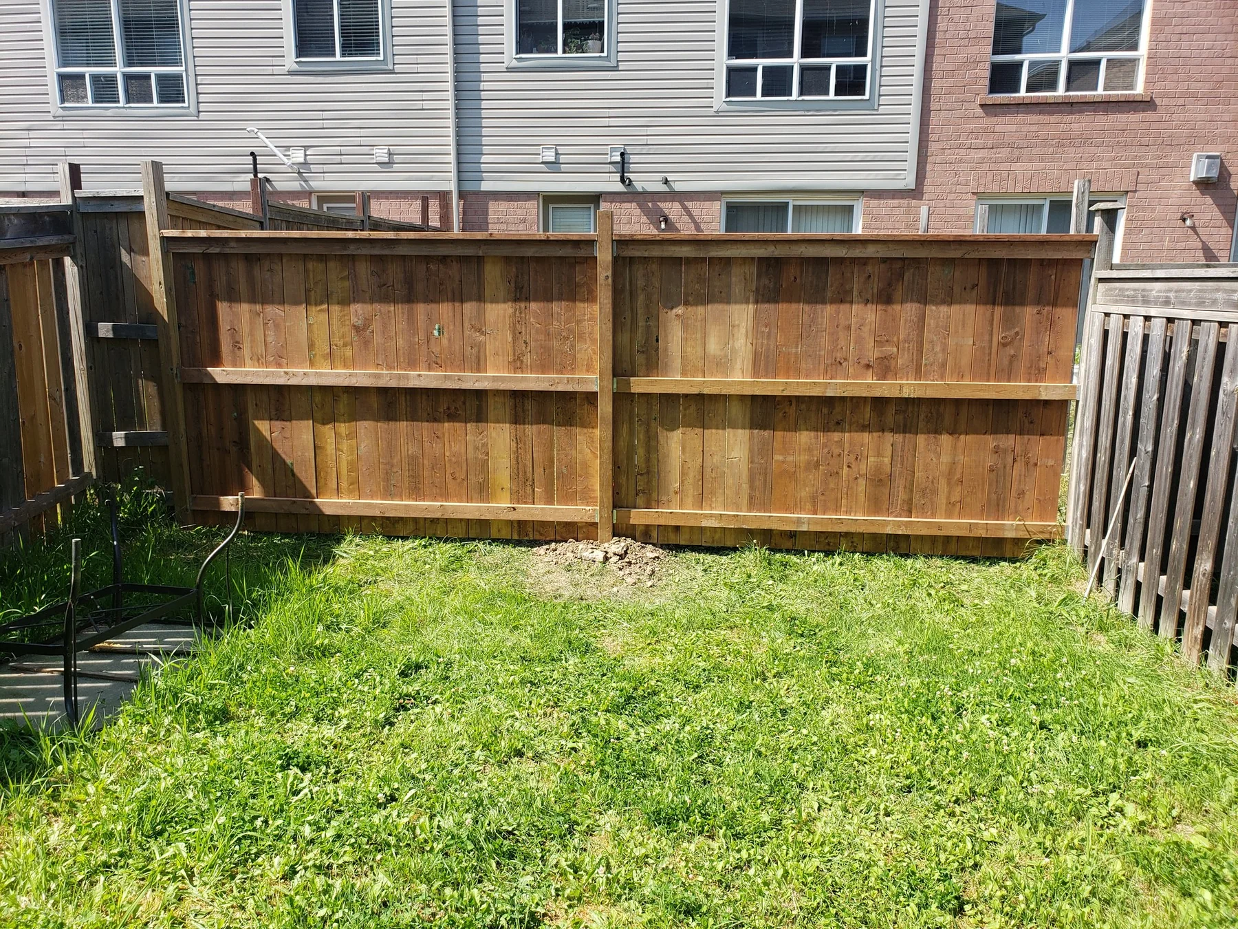 Interior view of posts and rails on a completed backyard fence