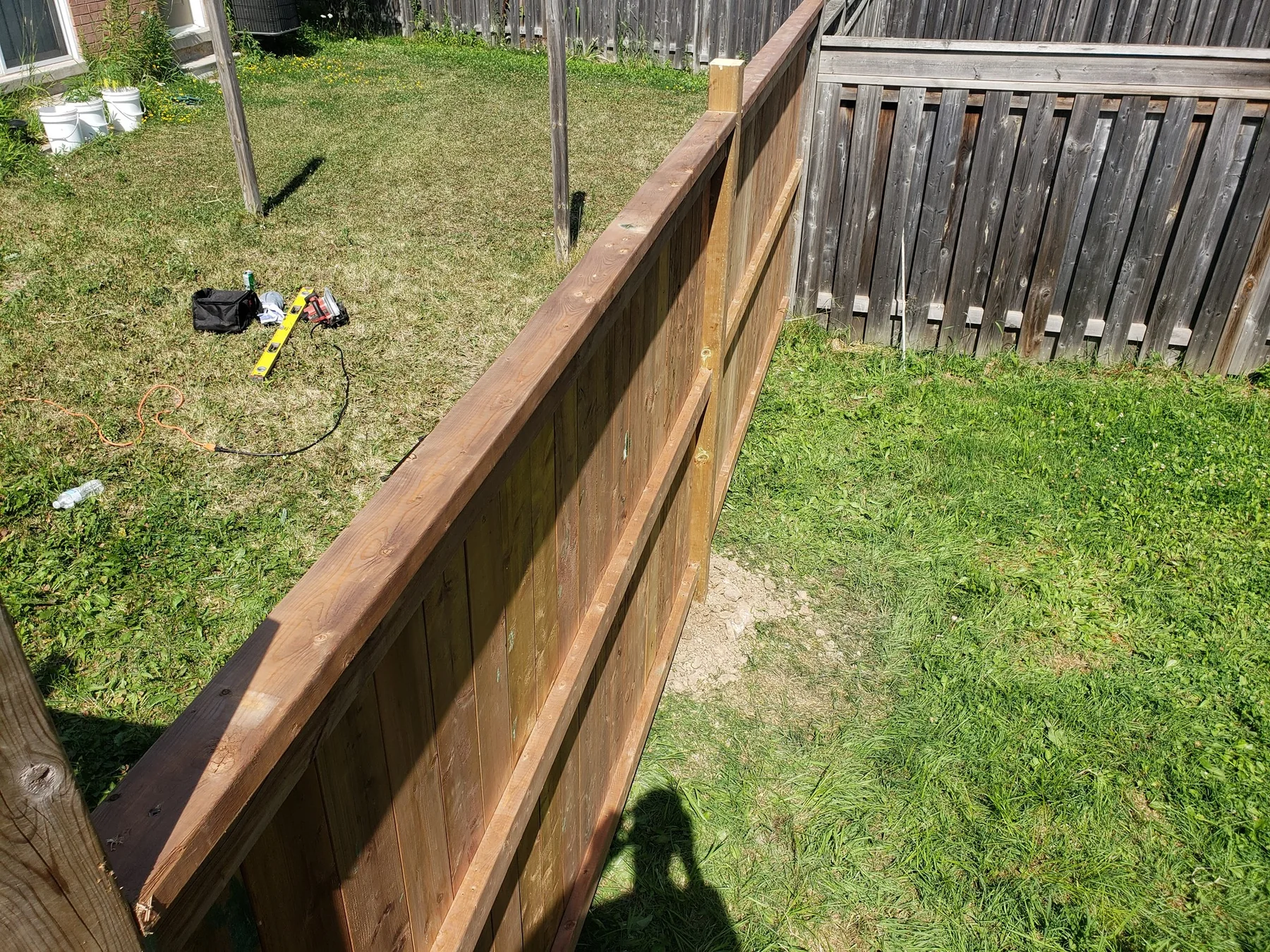 Close view along the capped top rail of a backyard cedar fence