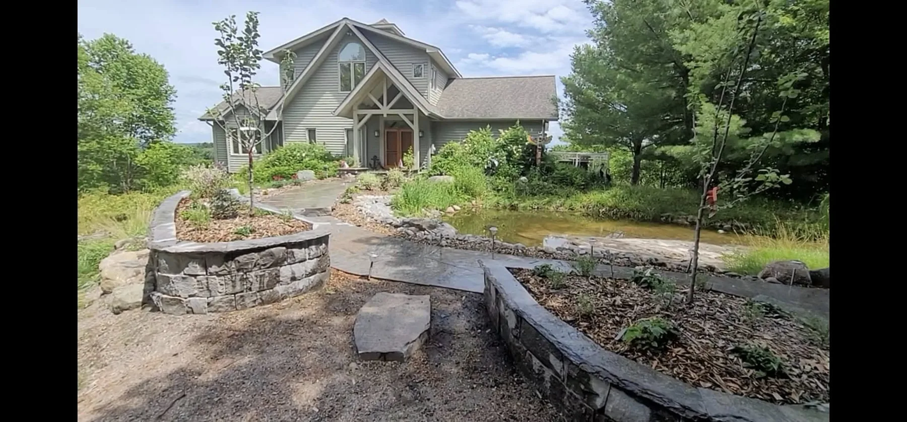 Completed granite entry landscape with planters and walkway