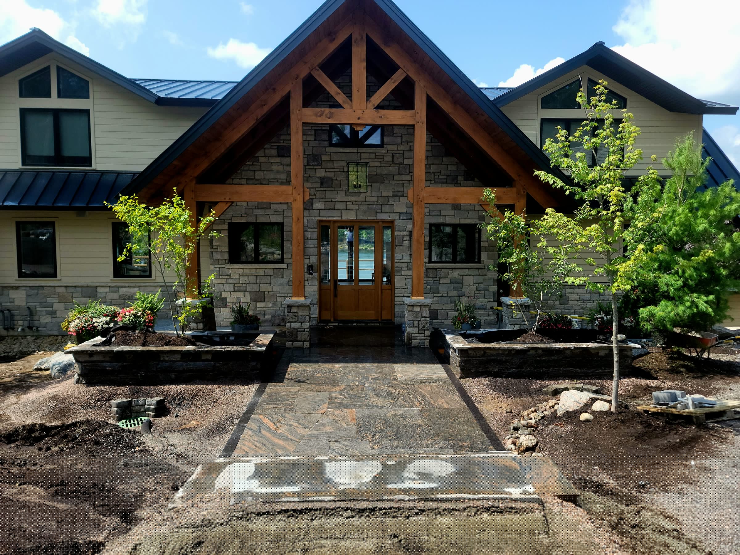 Front entry stonework and raised planter walls near completion