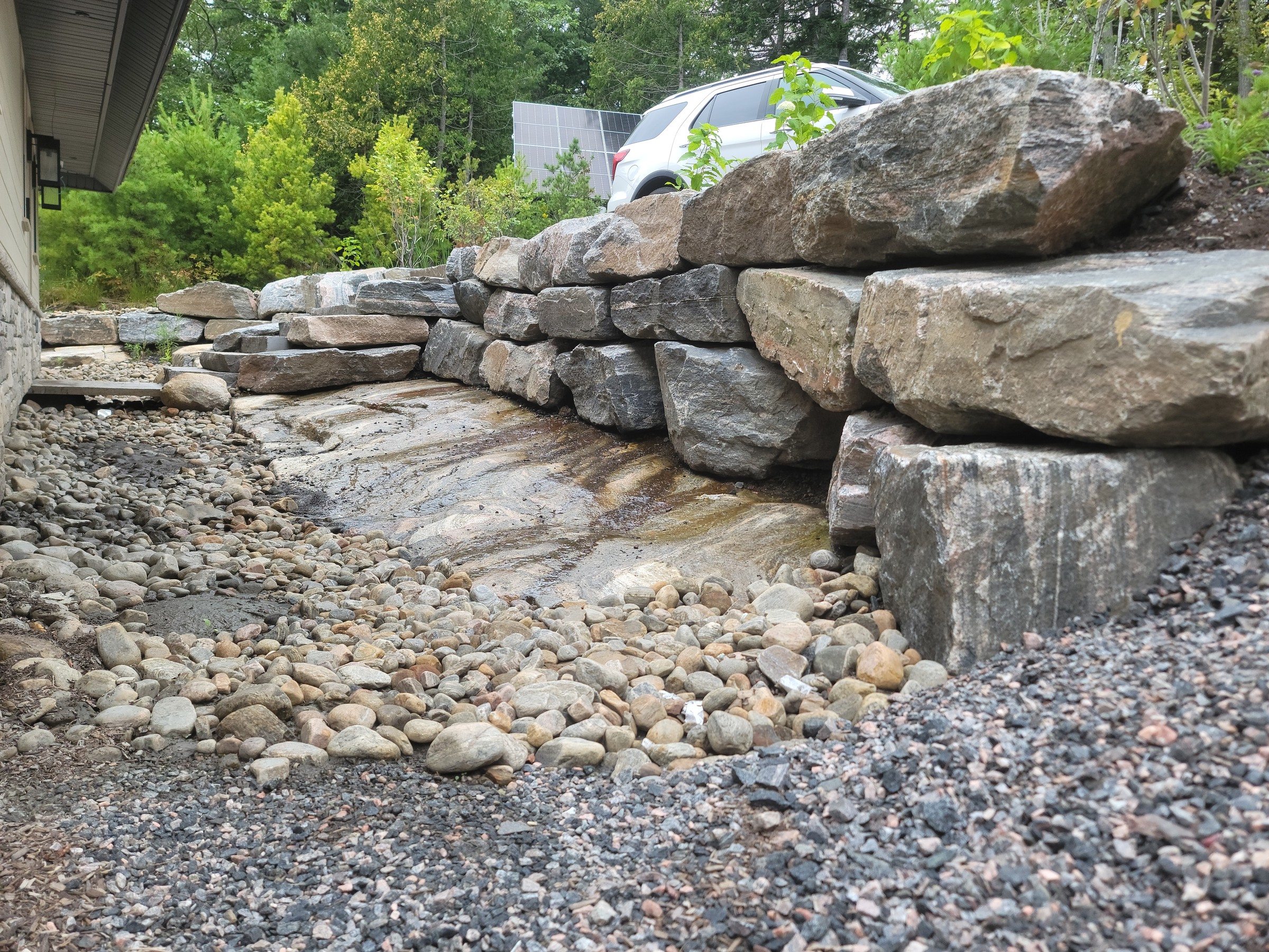 Completed rock wall and drainage-edge transition