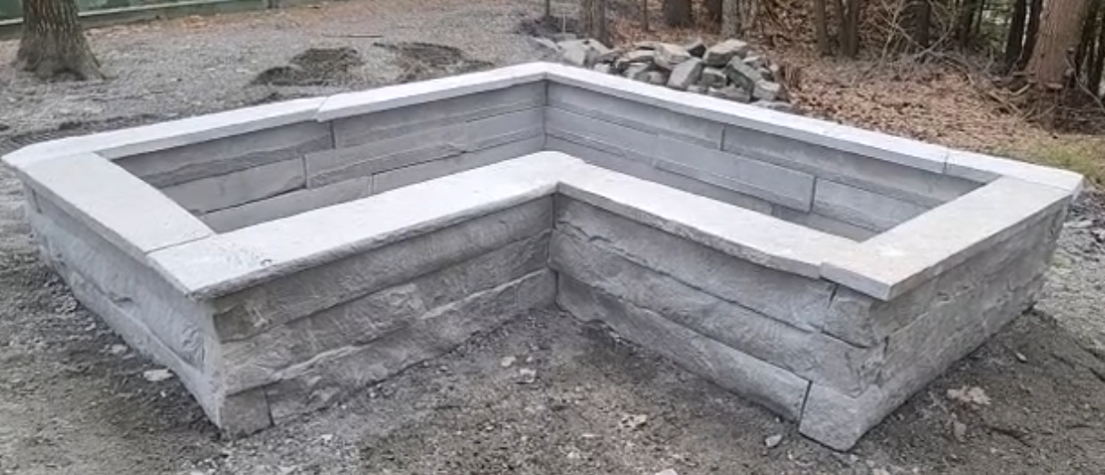 Completed L-shaped granite planter with light granite coping