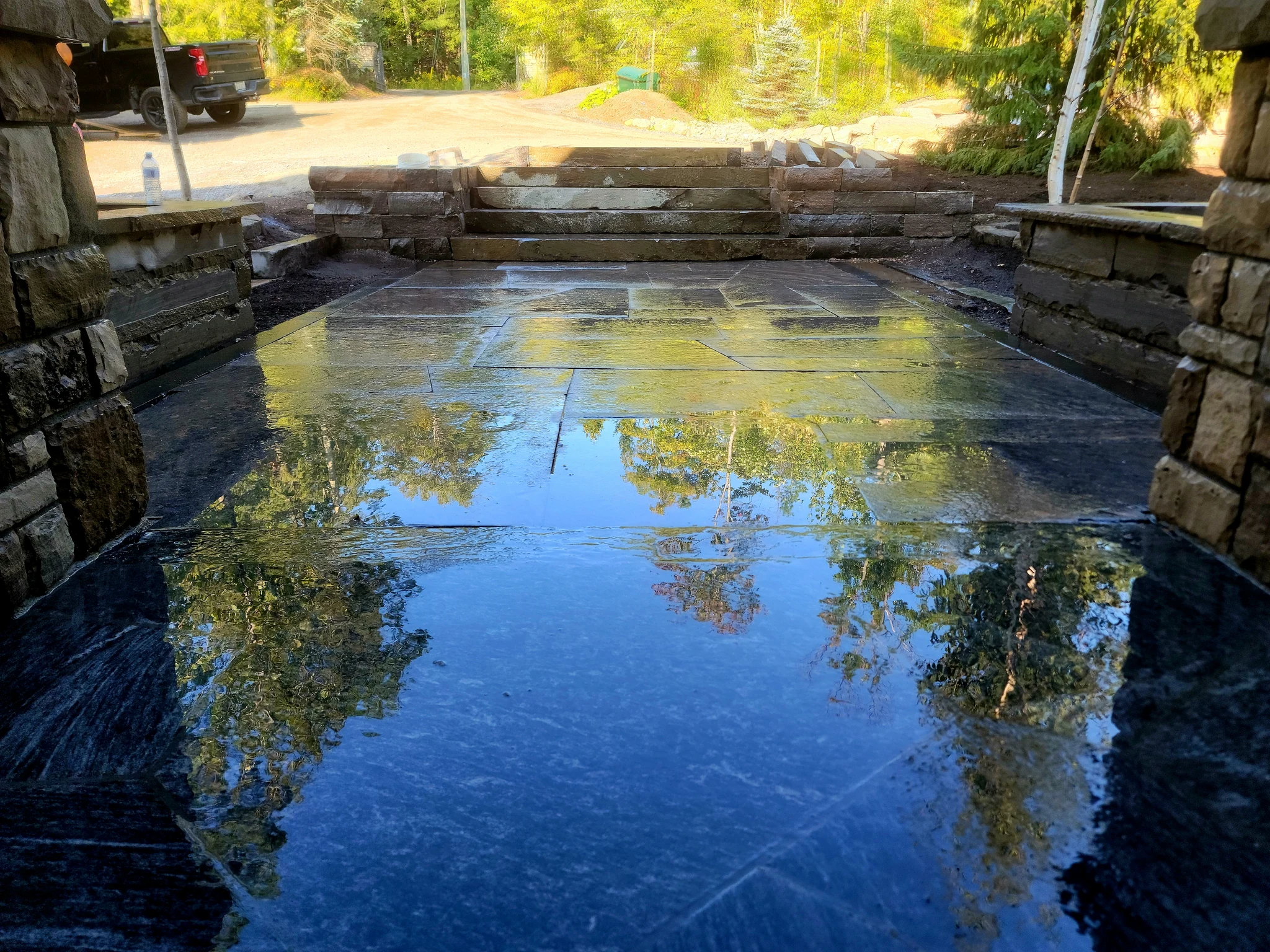 Finished granite entry court, planter walls, and stairs