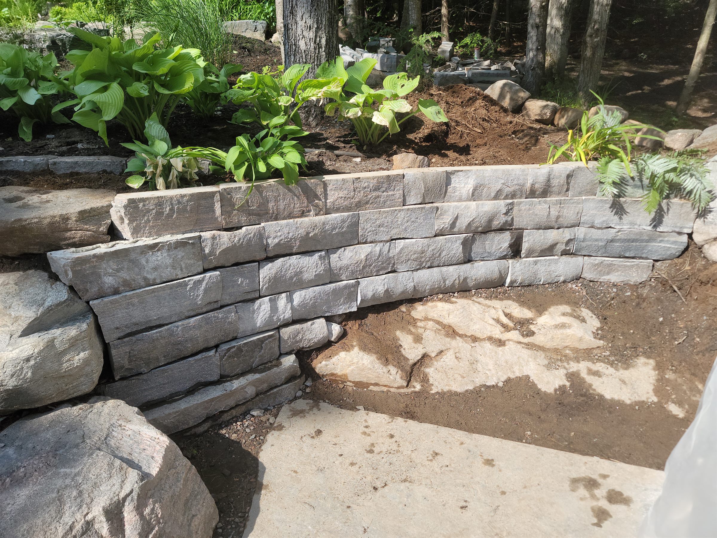 Natural-stone garden retaining wall construction detail