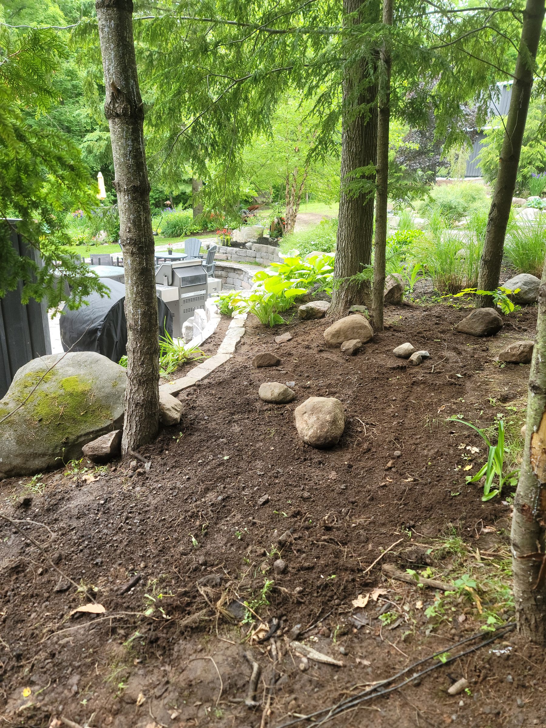 Lower garden slope prepared for retaining-wall stonework