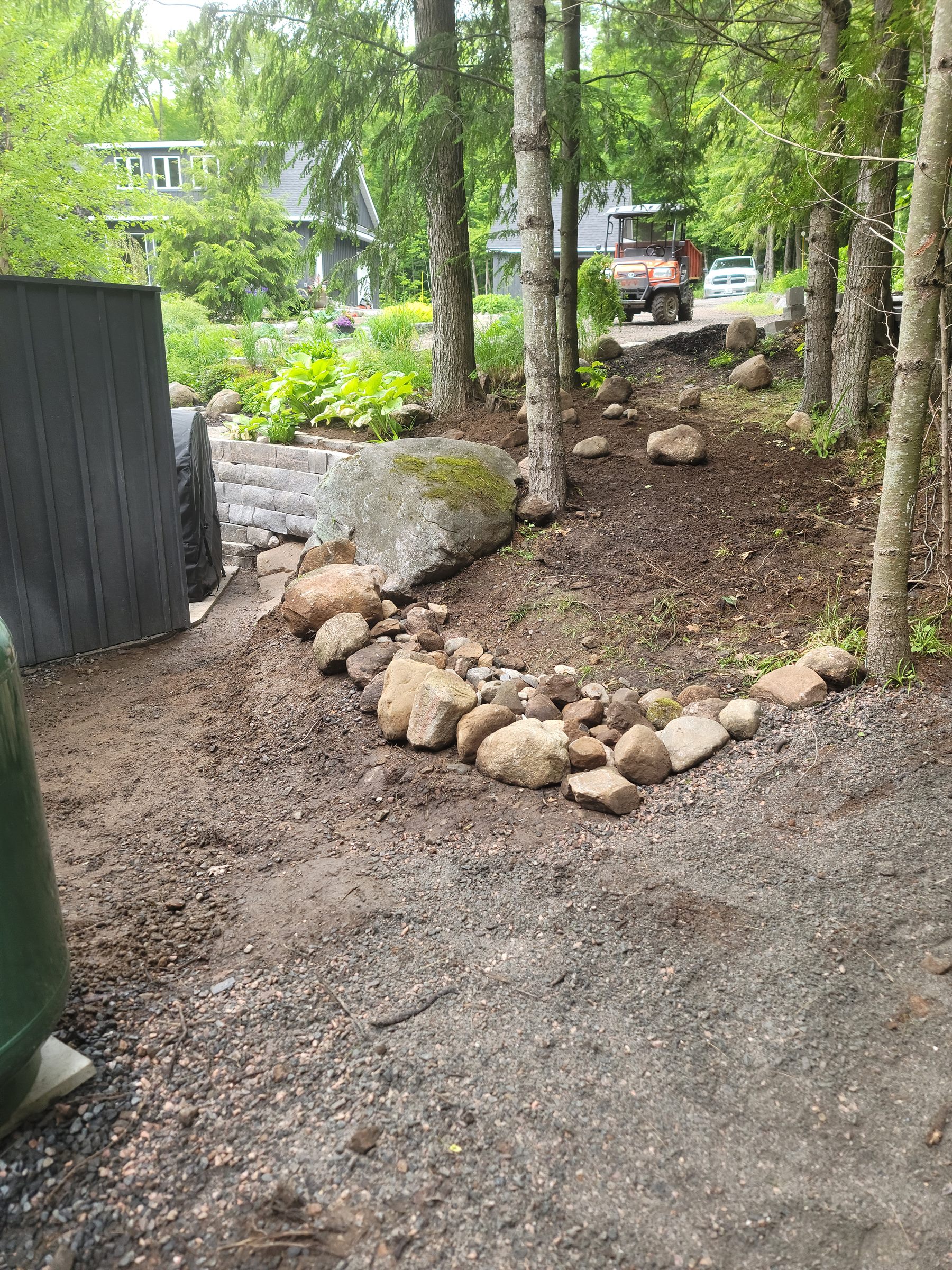 Lower garden grading and retaining-wall layout in progress