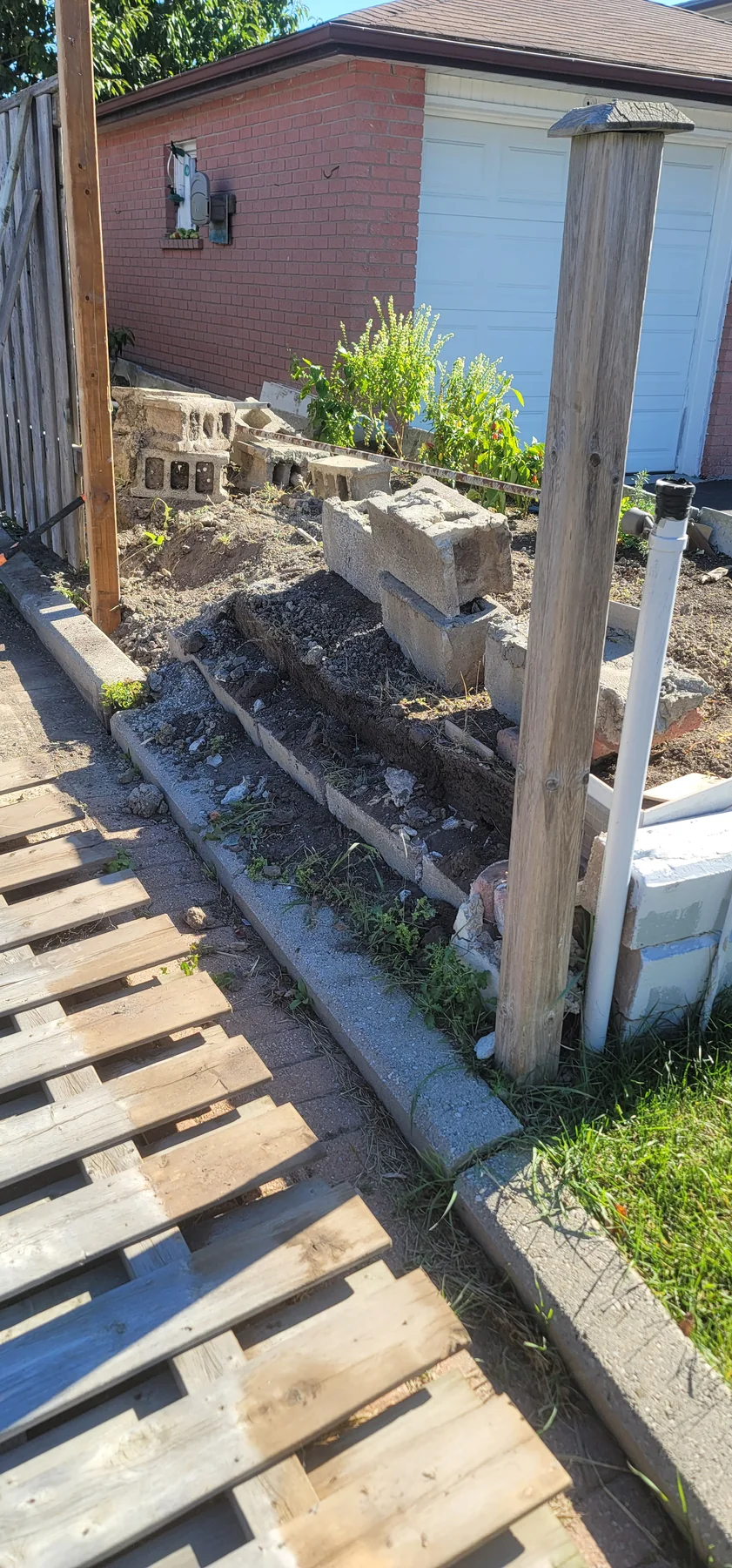 New wood support post installed along the existing garden fence