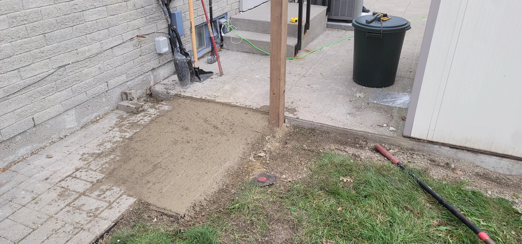 New wood post set beside a prepared walkway transition